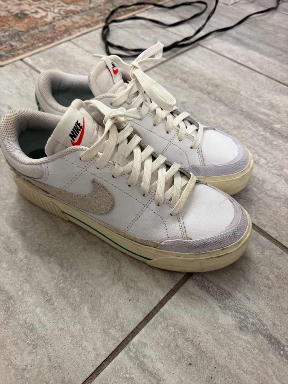 Nike White Low-Top Sneakers with Beige Suede Swoosh and Green Stripe